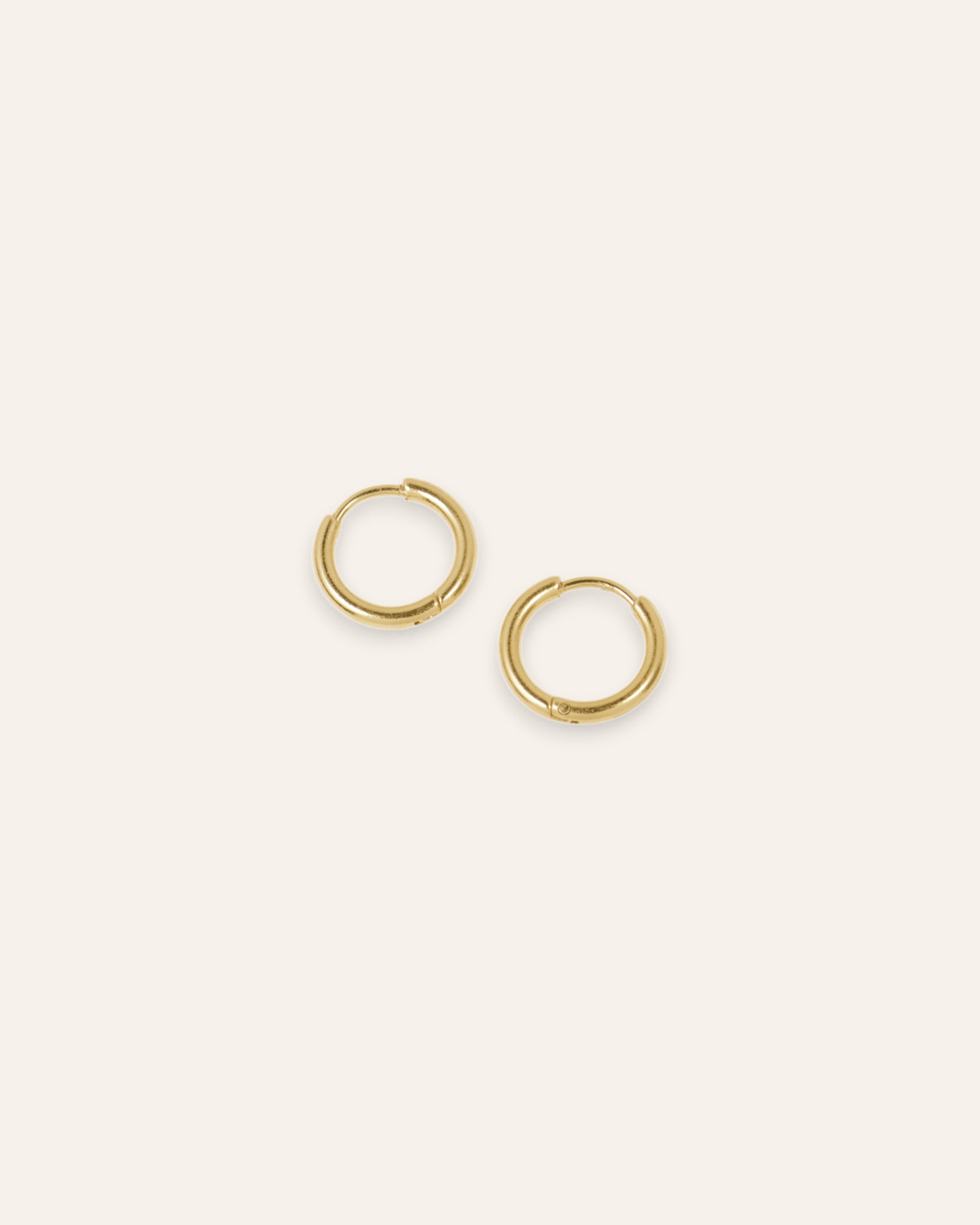 ll➤ Small smooth round hoop earrings, 24k gold plated. Timeless and elegant jewelry to enhance your ears. Order from Aglaia.